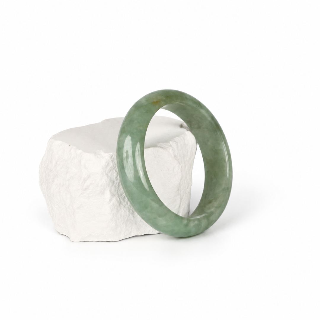 Light green Jadeite bangle, hero view on white stone
